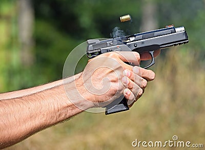 Shooting wigh a pistol Stock Photo