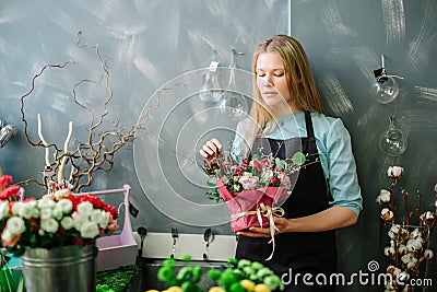 Shop assistant being lost in reverie in shop Stock Photo