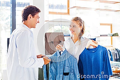 Shop assistant helping to choose clothes Stock Photo