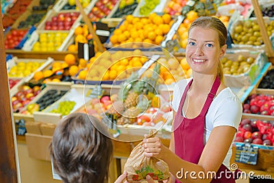 Shop assistant serving customer in grocers Stock Photo