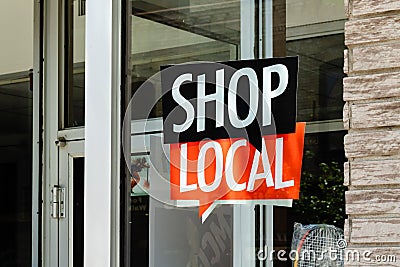 Shop local sign on storefront of small town business Stock Photo