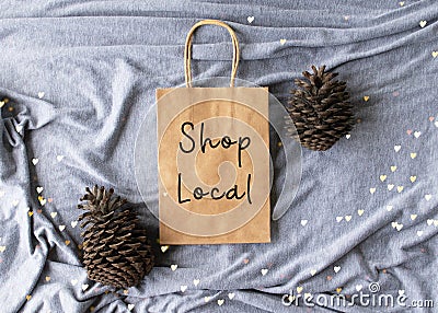 `Shop Local` text on a plain brown paper bag flat lay Stock Photo