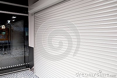 Shop window with roller shutters for protection from vandals Stock Photo