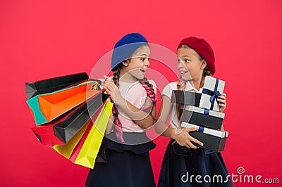 Shopaholic concept. Shopping become fun with best friends. Children satisfied by shopping red background. Obsessed with Stock Photo