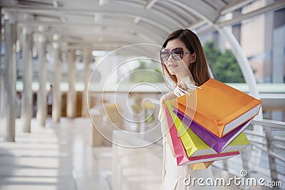 Shopaholic Women holding shopping bags ,money ,credit card person at shopping malls.Fashionable Woman love online website with Stock Photo