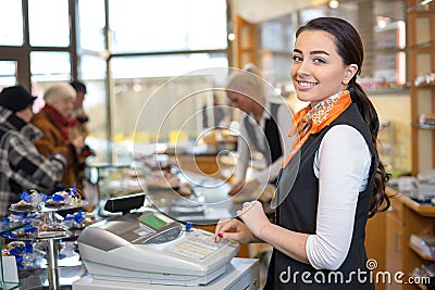 Shopkeeper and saleswoman at cash register or cash desk Stock Photo