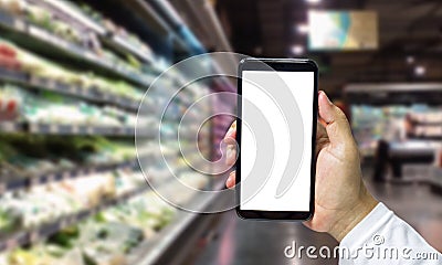 Shopper Mobile smart phone in hand, and see more detail and compare the prices in supermarkets Stock Photo