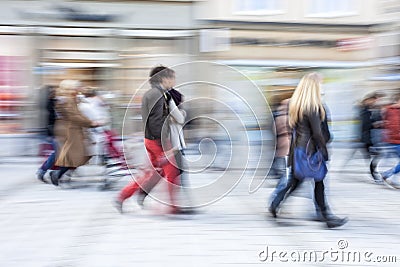 Shopper walking in front of shop window Stock Photo