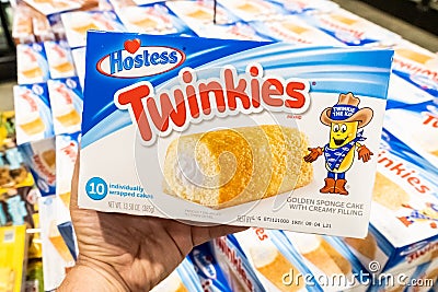 Shoppers hand holding a package of Twinkies brand golden sponge cakes Editorial Stock Photo