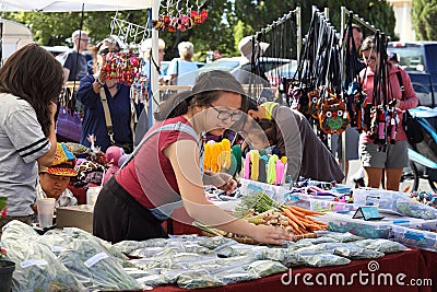 Shoppers inspect goods at a farmers and artisan market. Editorial Stock Photo