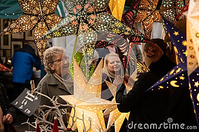 Christmas Market Stand Selling Colourful Illuminated Festive Stars. Editorial Stock Photo