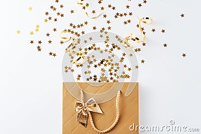 Shopping bag with festive confetti on white background Stock Photo