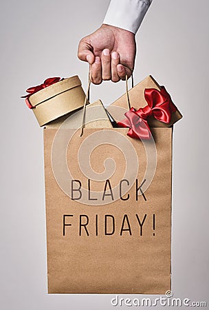 Shopping bag full of gifts and text black friday Stock Photo