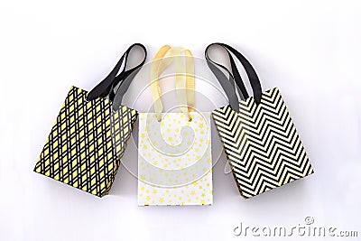 Shopping bags, gift boxes in modern style on white background. Golden stars, black geometric lines- fashion modern design. Minimal Stock Photo