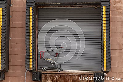 Shopping cart abandoned at a unloading dock Stock Photo