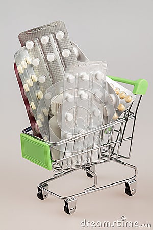 Shopping cart with blisters of tablets and pills concept of self-treatment and purchase of medicines Stock Photo