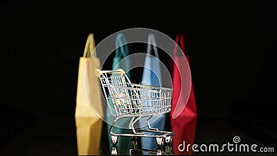 Shopping cart with blurred shopping bags background Stock Photo