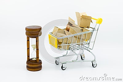 Shopping cart with coins inside box and hourglass for retail business. Image use for shopping, marketing place world wide, Stock Photo