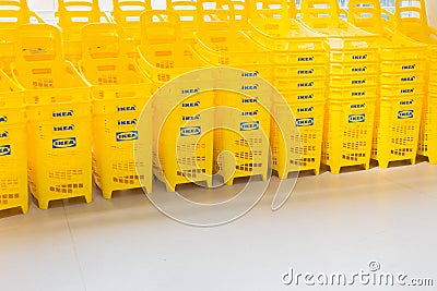 Shopping cart with commercial logo Ikea. Ikea shopping mall. Yellow market trolleys of famous swedish company. Editorial Stock Photo