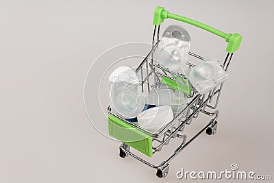 shopping cart shopping cart filled with various containers and packages with modern soft contact lenses Stock Photo