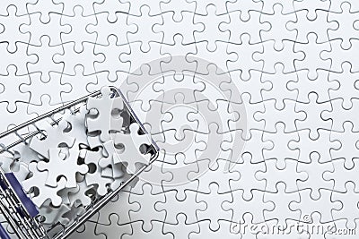 Shopping cart full of jigsaw puzzle on white jigsaw puzzle backgruond, Business solution concept ,key for success. Stock Photo