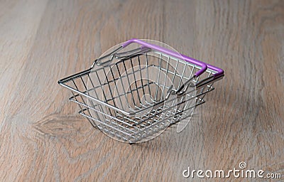 Shopping cart in a minimalist style. Shopping basket at the supermarket. Sale, discount, the concept of shopaholism. Stock Photo