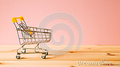 Shopping cart on wooden table Stock Photo