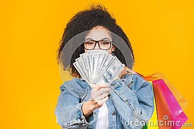 Shopping Concept - Portrait young beautiful african american woman smiling and joyful with colorful shopping bags and money Stock Photo
