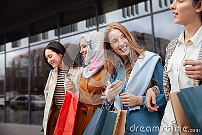 Shopping. Diversity Women Holding Bags. Group Of Smiling Multiethnic Women Standing Near Mall. Stock Photo