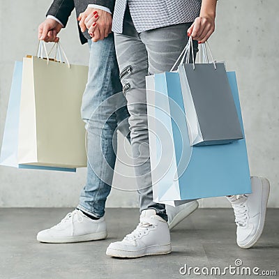 Shopping holiday gift casual couple walk hold bags Stock Photo