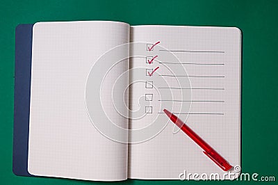 Shopping list with multiple items. Open notebook on green background Stock Photo