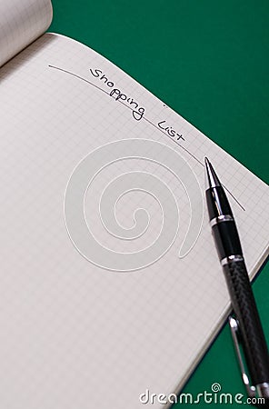 Shopping list with multiple items. Open notebook on green background Stock Photo