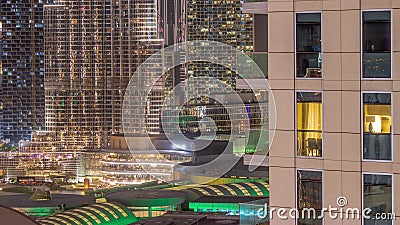 Shopping mall exterior with reastaurants on balconies night timelapse in Dubai, United Arab Emirates Editorial Stock Photo