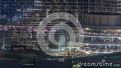 Shopping mall exterior with reastaurants on balconies night timelapse in Dubai, United Arab Emirates Editorial Stock Photo