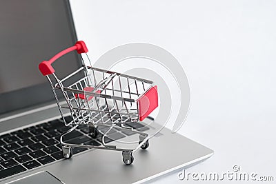 Shopping noline. Buying cart on keyboard of the laptop Stock Photo