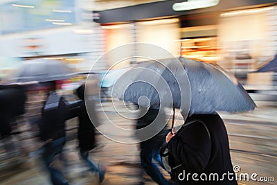 Shopping people walking in the rainy city Stock Photo