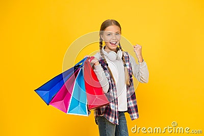 Shopping and sale on black friday. Addicted consumer. Dive into shopping. Happy child with paper bags. Little girl smile Stock Photo