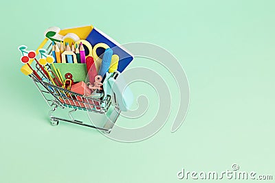 Shopping trolley full of school supplies. Preparation to school, shopping, sale, deals, discounts, promotion Stock Photo