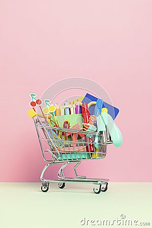 Shopping trolley full of school supplies. Preparation to school, shopping, sale, deals, discounts, promotion Stock Photo