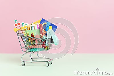 Shopping trolley full of school supplies. Preparation to school, shopping, sale, deals, discounts, promotion Stock Photo