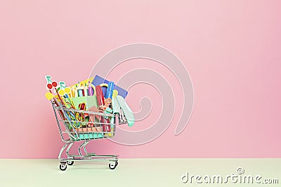 Shopping trolley full of school supplies. Preparation to school, shopping, sale, deals, discounts, promotion Stock Photo