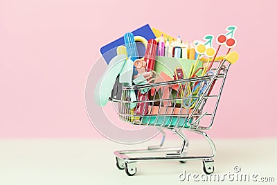 Shopping trolley full of school supplies. Preparation to school, shopping, sale, deals, discounts, promotion Stock Photo