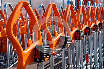 Shopping trolleys with orange handles lined up at hardware store Stock Photo