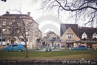 Shops along River Windrush in Bourton-on-the-Water, a beautiful famous small village in rural Cotswolds area of England. Taken in Editorial Stock Photo