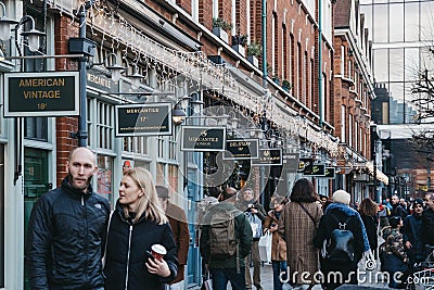 Shops in Spitalfields Market, London, UK, people walking past, selective focus Editorial Stock Photo