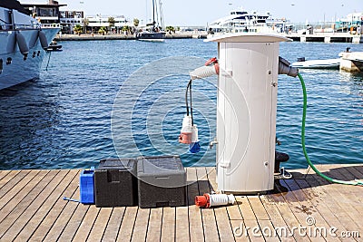 Shore Based Electricity Supply Appliance Power Supply And Battery Charged on the dock . Stock Photo