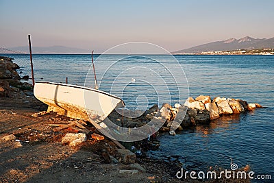 Shored fishing boat, sea and sky at sundown in Urla, Izmir, Turkey Editorial Stock Photo