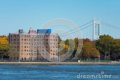 Shoreline of Astoria Queens New York with Public Housing Buildings and the East River with Colorful Autumn Trees and a Bridge in t Stock Photo