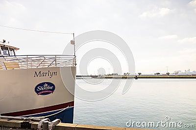 A Shoreline Sightseeing ship named Marlyn docked on the blue waters of Lake Michigan on a cloudy autumn day in Chicago Illinois Editorial Stock Photo