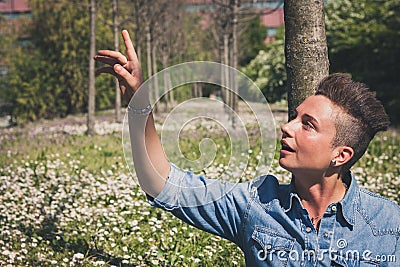 Short hair girl sitting in the grass Stock Photo